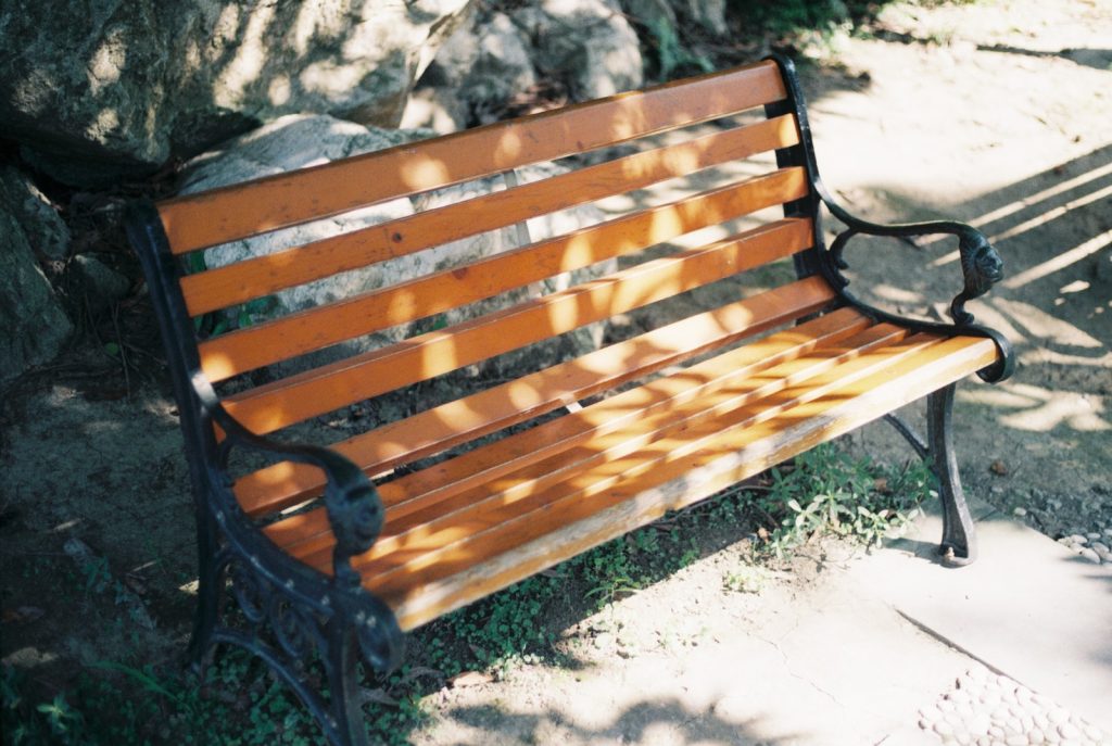 brown wooden bench on brown soil