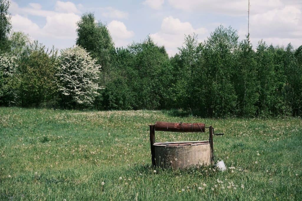 a barrel sitting in the middle of a field